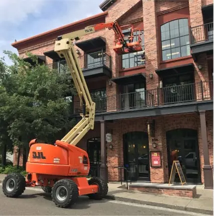 Construction worker installing new window in house