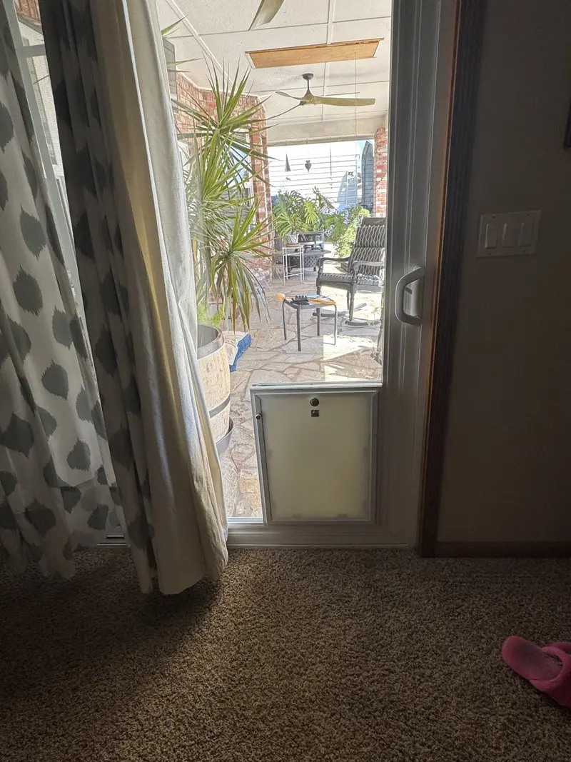 Inside view of a sliding door pet door with the security panel in place