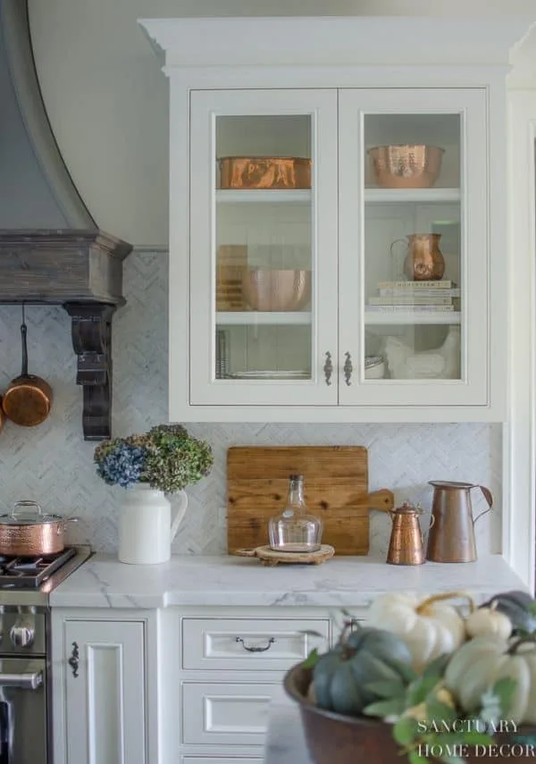 how to style glass kitchen cabinets