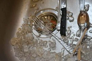 how to get broken glass out of sink